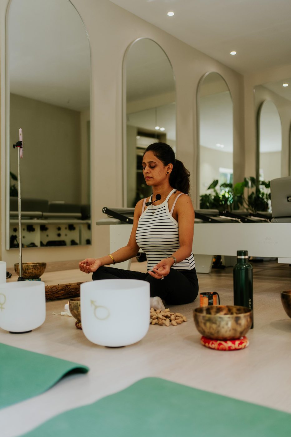 Nikita Gehlot, founder of Vrnda, meditating with singing bowls
